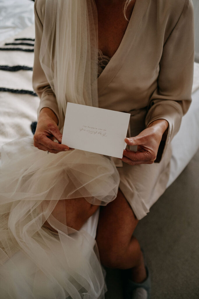Bride on the wedding morning reading a love note from her husband to be