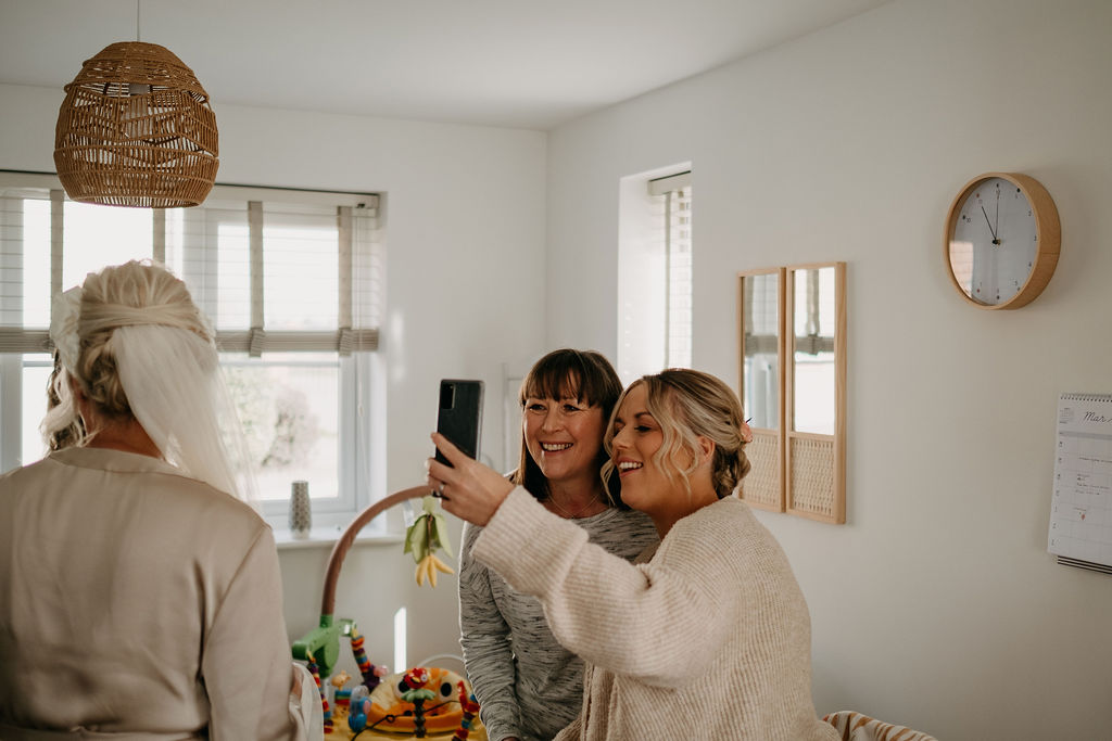 Mother & a bridesmaid taking a selfie whilst getting ready