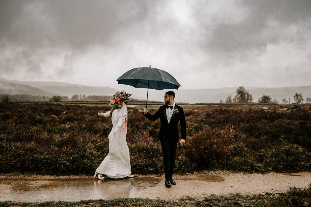 Rainy Wedding Photography Tips - Bride & Groom with umbrella in the peak district