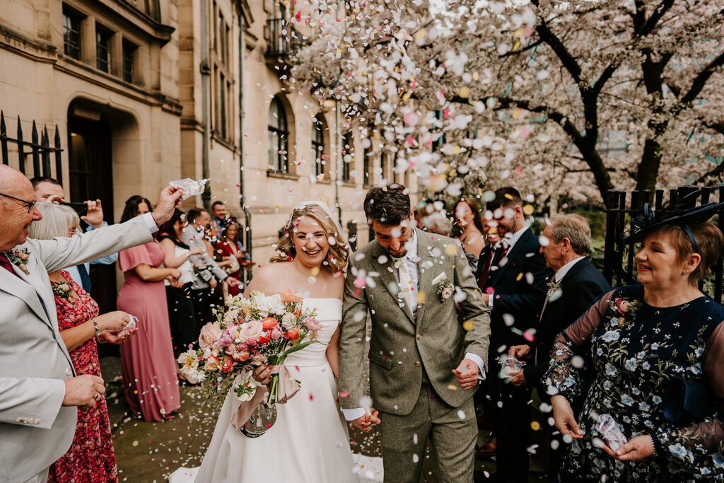 Guests throwing confetti outside Sheffield Town hall  in spring