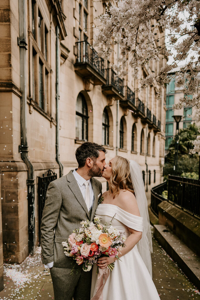 couple kissing outside Sheffield Registry Office in spring