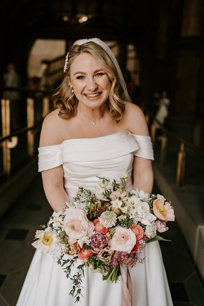 Bride smiling outside Sheffield Registry Office in spring
